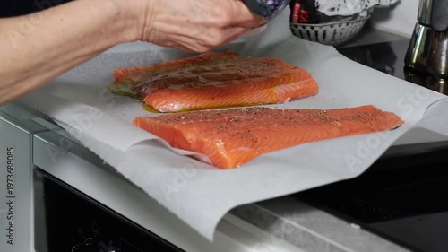 Stockholm, Sweden A cook prepares a side of salmon in a domestic kitchen for a dinner party.