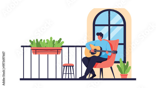 Young man sitting on a balcony in a comfortable armchair and playing an acoustic guitar while enjoying the fresh air and lush green plants.