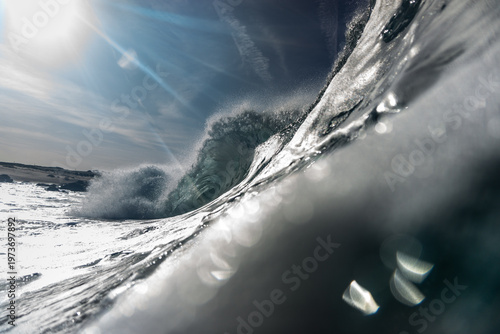 Bild auf Leinwand Dynamic closeup of a breaking wave under a dramatic sky, capturing swirling water, bright reflections, and coastal energy in a moody, immersive seascape scene