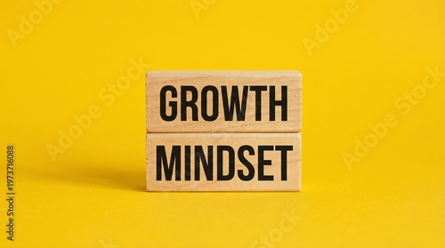 Growth Mindset: Wooden blocks spell out GROWTH MINDSET on a bold yellow backdrop. This image embodies personal development and self-improvement