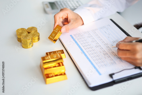 Gold Trading Businessman invest in trading gold, calculating profit price of buy and sell gold.