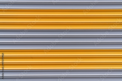 Yellow and Gray Metal Roller Shutter Door Abstract Industrial Background