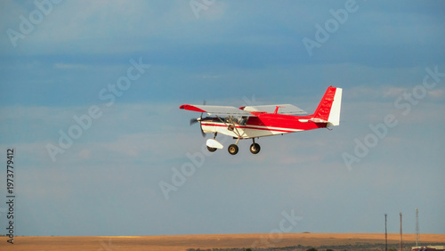 Bild auf Leinwand A light multi-purpose aircraft in the sky over the Crimean steppe