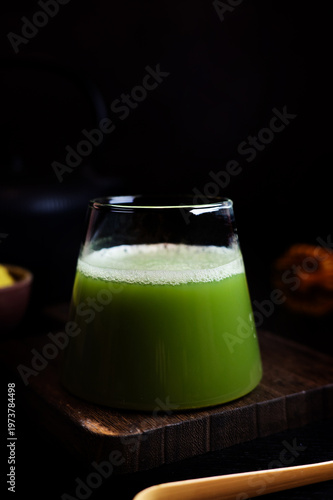 Matcha tea with fine foam served in a glass.