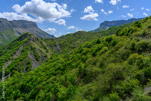 Lush Green Mountain Landscape Under a Blue Sky with Clouds. Dagestan Russia.