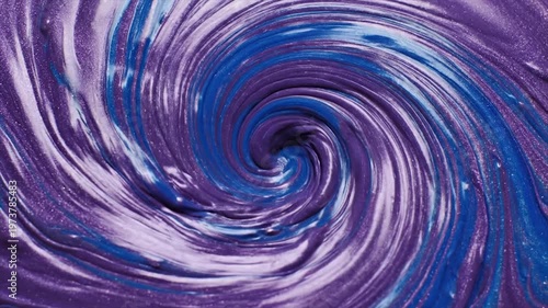 vibrant abstract swirl of purple and blue fluid paint texture in motion