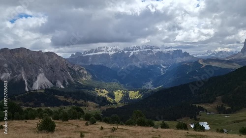 Mount Seceda with mountain scenery and path to mountain refuges in cloudy weather.