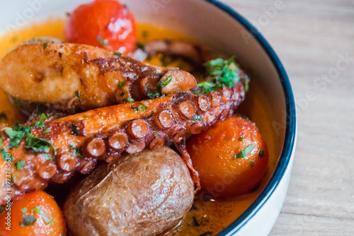 fried octopus with grilled vegetables on a plate