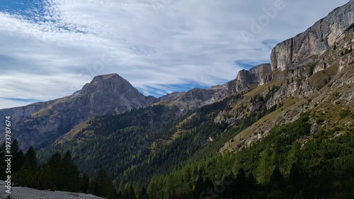 The winding Vallunga hiking trail among the rocks with a mountain refuge in the Puez Geisler nature park in Selva. Panorama.