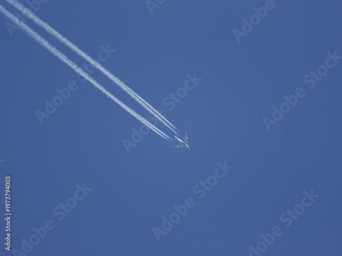 Aircraft at high speed leaving contrails behind.