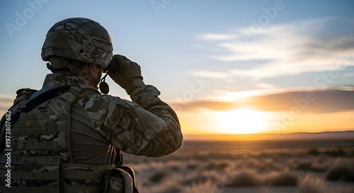 Military soldier observing the horizon with binoculars during a vibrant sunset, wearing camouflage gear and protective helmet, focused surveillance in a desert landscape.