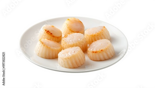Fresh raw scallops on a plate against a white background.