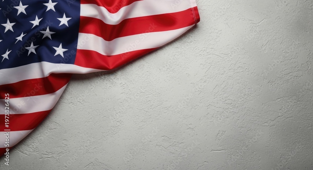 Obraz premium Draped american flag against a textured gray wall