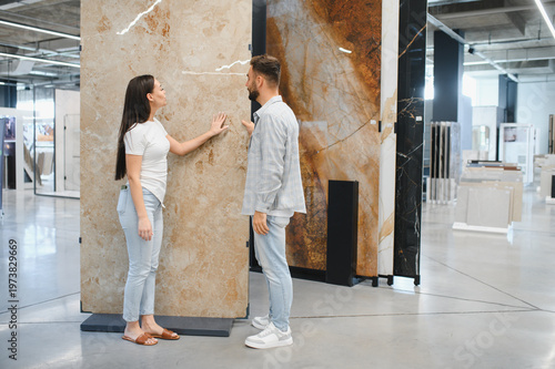 Photos Couple choosing large format tile for home renovation