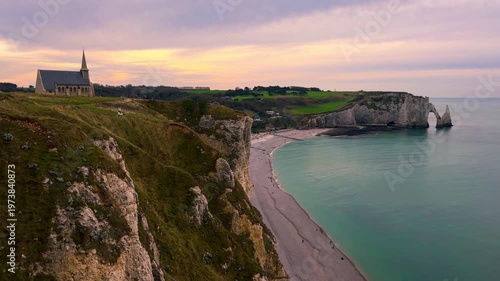 Sunset view from above of chapel and picturesque coastal limestone cliffs and the English Channel town of Etretat, Normandy, France. High quality 4k footage