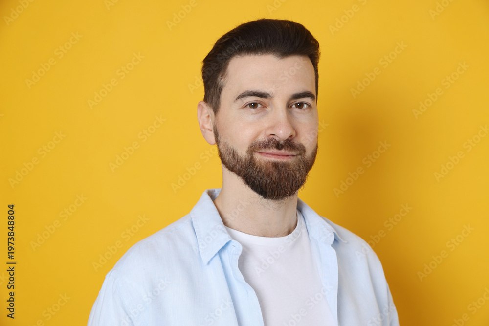 Obraz premium Portrait of handsome man on orange background