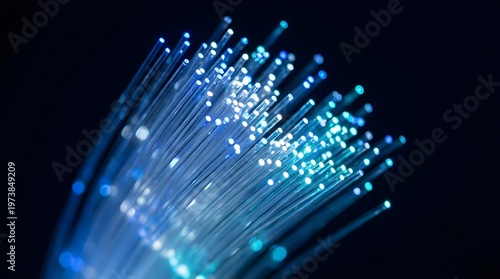 Close-up of glowing blue fiber optic cables on dark background