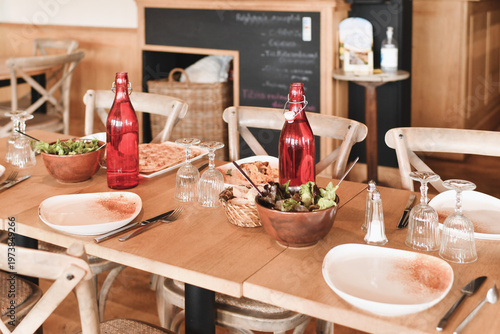 Cozy restaurant table setting with plates glasses and rustic decor