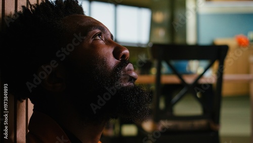Foto Lonely man, black person with heartbreak, dealing with disappointment, sadness and emotional fatigue causing depression and anxiety