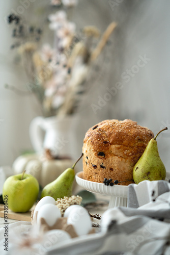 Easter bread with eggs and spring decoration, cozy rustic still life