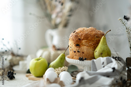 Easter bread with eggs and spring decoration, cozy rustic still life