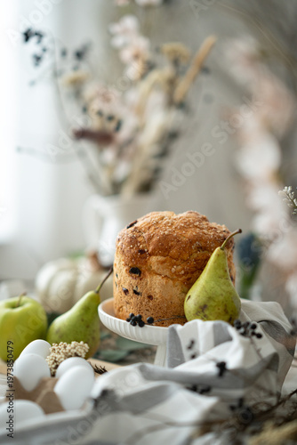 Easter bread with eggs and spring decoration, cozy rustic still life