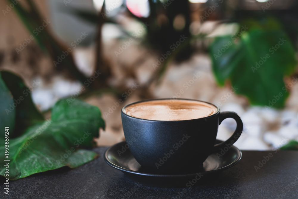 Fototapeta premium Minimalist Coffee Composition with Stones and Leaf. Coffee in Black Cup with White Pebbles and Leaf. Minimal Zen Style Coffee Setup with Natural Elements. 