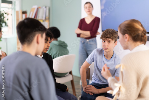 Фотография Diverse teenage students working in two separate teams during interactive group