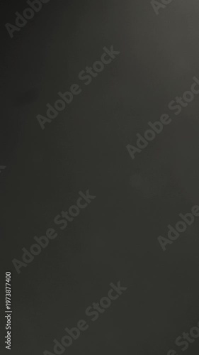 Metal scissors cutting purple thread on dark background