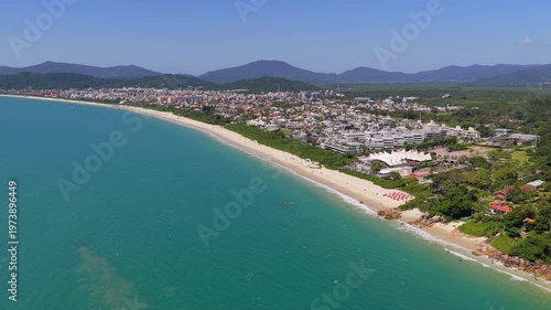 Sweeping coastal panorama of Jurere Internacional shoreline with lush vegetation, Florianopolis.