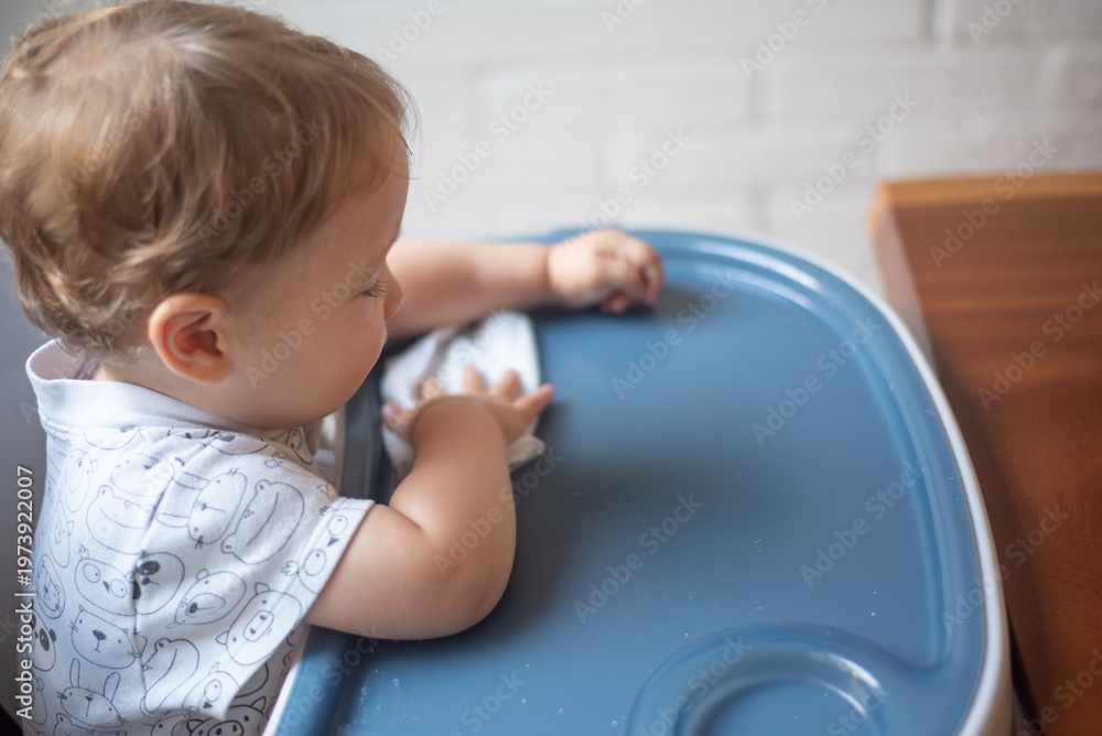 Fototapeta premium baby wiping the table after eating
