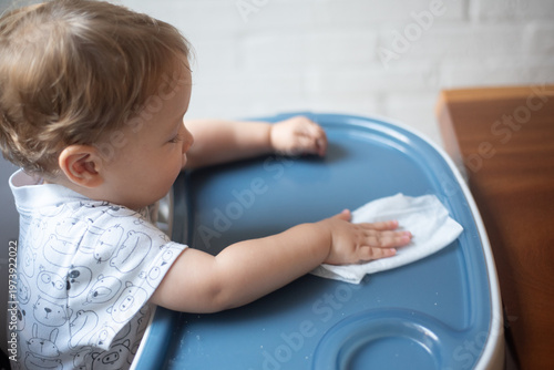 baby wiping the table after eating