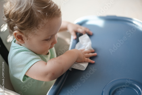 baby wiping the table after eating