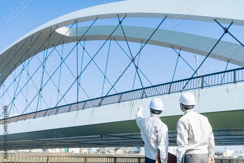 橋を点検する男性作業員のグループ