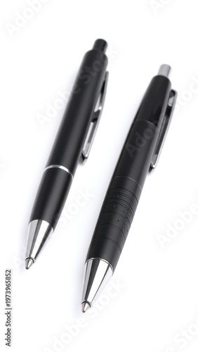 Two black pens with silver tips on a white background