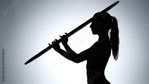 Woman holding long stick sideways motion.