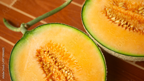 Close up of cantaloupe melon on wooden table.