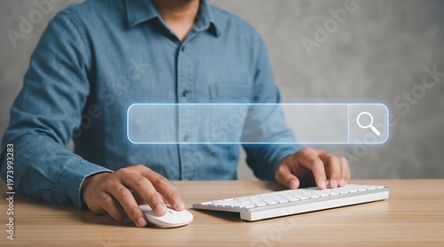 Person using a computer keyboard and mouse to perform an internet search
