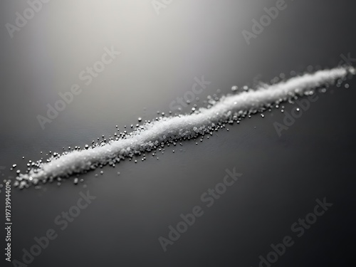 White granular substance trail on gray surface for conceptual visuals