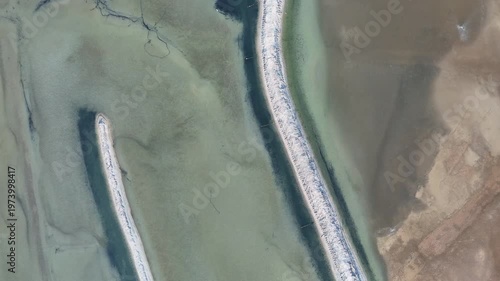 Aerial Top-Down View of White Embankments in Shallow Water with Abstract Wetland Textures