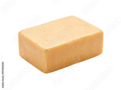 Solid rectangular block of smooth pale orange cheddar cheese sits on an isolated transparent background image
