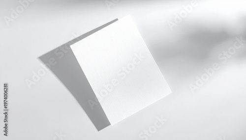 Blank white paper card floating in the air with soft shadows casting from above on a clean white background