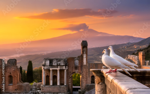 Ruins of ancient Greek theater in Taormina, and Etna volcano in the background at sunset. A beautiful wallpaper with a pair of doves.