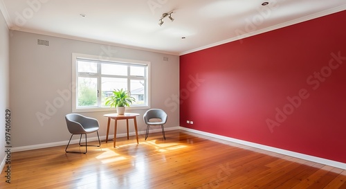 A room with a wooden floor and a red wall