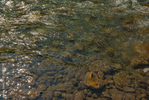 Scenic summer landscape of Elbow Falls in Kananaskis Country, Alberta, Canada. Beautiful waterfall cascading over rocky cliffs into the Elbow River with evergreen pine forest and blue sky Canada