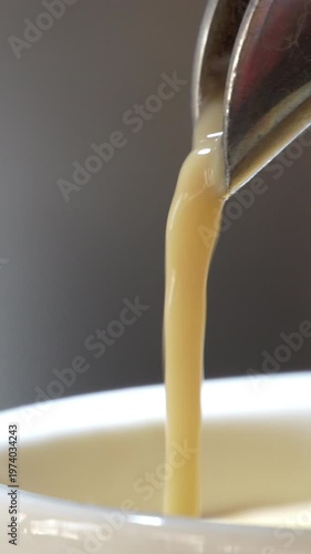 4K Vertical video Close-up of espresso flowing from coffee machine showing rich smooth liquid texture Fresh brewed coffee, Concept ideal for cafe barista and commercial beverage advertising.
