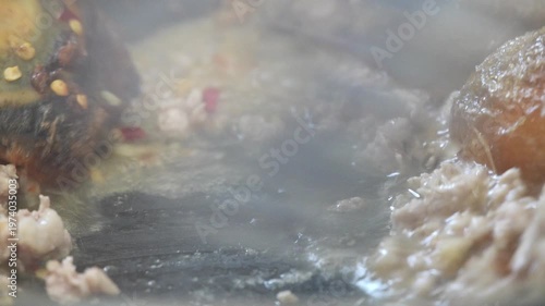 4K Close-up of Thai basil stir fry Pad Kra Pao cooking in pan with steam and rich texture Traditional Thai street food, Concept ideal for food restaurant and commercial use.