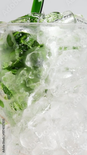 4K Vertical video Refreshing iced matcha green tea drink with crystal clear ice cubes and vibrant green color Close-up beverage, Concept representing freshness summer and healthy lifestyle for commer