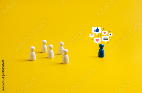 Fotografi Blue human figure surrounded by social media icons standing apart from white figures on yellow background