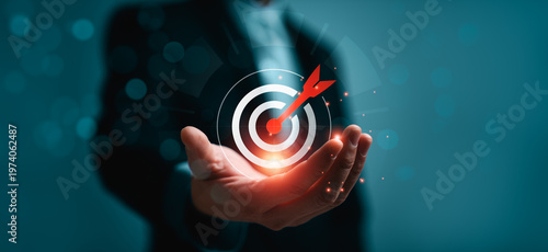 Business goal achievement and strategic target success concept with glowing target icon and arrow in hand, representing precision planning, KPI performance, leadership strategy, successful business